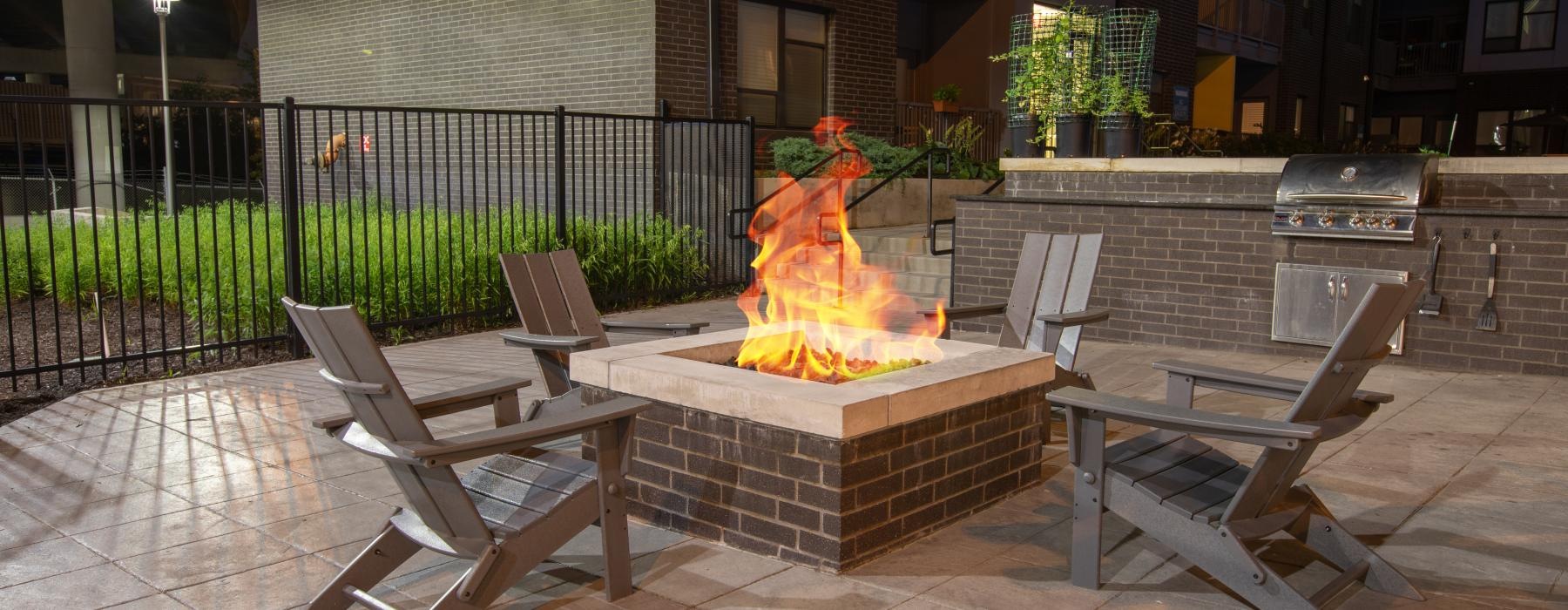 a fire pit with benches and a fire in it
