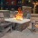 a fire pit with chairs and a fire in it