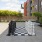 a courtyard with a chess board in it and buildings around it