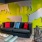 a room with a couch and a table with a painting on the wall
