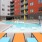 a swimming pool in a courtyard between buildings